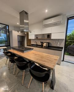 a kitchen with a wooden table and some chairs at LoftMerak in Pereira