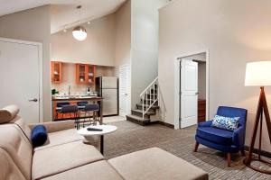 a living room with a couch and a kitchen at Residence Inn Los Angeles LAX/Manhattan Beach in Manhattan Beach