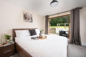 a bedroom with a large bed and a large window at Robins Rest, Nr Perranporth in Perranporth