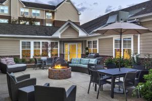 a patio with tables and chairs and a fire pit at Residence Inn Pittsburgh Cranberry Township in Cranberry Township