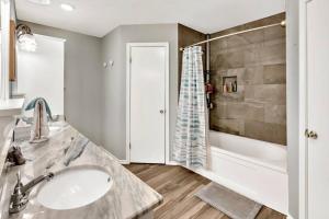 a bathroom with a sink and a shower at New Cozy Retreat Located 15 minutes to Waco in Hewitt