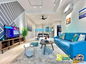 a living room with a blue couch and a piano at OngKimWee Residence By Heystay Management in Melaka