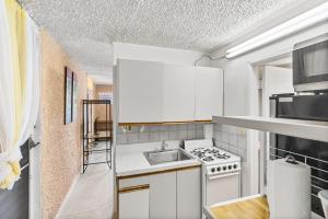 a kitchen with a sink and a stove at Not only you have a view condo in Christiansted