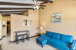 a living room with a blue couch and a table at One blue Caribbean View condo in Christiansted