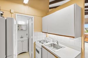 a kitchen with a sink and a stove at One blue Caribbean View condo in Christiansted