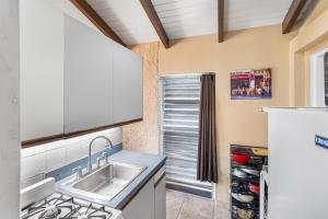a kitchen with a sink and a counter top at Caribbean View Style condo in Christiansted