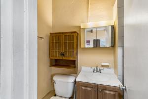 a bathroom with a toilet and a sink at Caribbean View Style condo in Christiansted