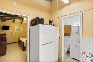 a kitchen with a white refrigerator in a room at One blue Caribbean View condo in Christiansted