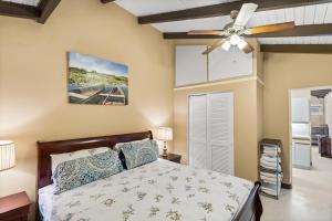 a bedroom with a bed and a ceiling fan at One blue Caribbean View condo in Christiansted