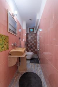 a pink bathroom with a sink and a toilet at Top Center Relax, NDK & Vitoshka str, FREE Secured parking in Sofia +16 photos