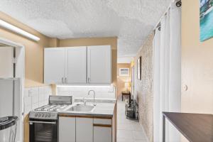 a kitchen with a sink and a stove at Caribbean View condo in Christiansted