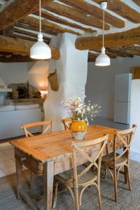 a dining room with a wooden table and chairs at Chez Fanny in Bédoin