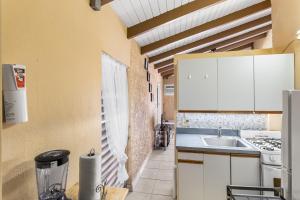 a kitchen with a sink and a stove at Caribbean View for You condo in Christiansted