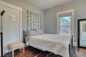 a bedroom with a bed and a window at Colorado Columbine Cottage in Colorado Springs