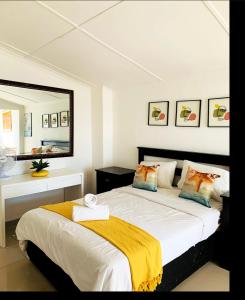 a bedroom with a bed with a yellow blanket on it at Hill Top Farm Lodge in Sea Park