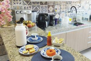 a kitchen with two plates of food on a counter at Village 2 suítes beira mar Itacimirim in Camaçari