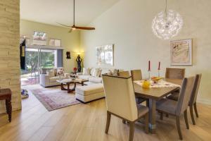 a dining room and living room with a table and chairs at Tennis, Golf and Pools Lovely Palm Desert Condo! in Palm Desert