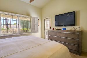a bedroom with a flat screen tv and a bed at Tennis, Golf and Pools Lovely Palm Desert Condo! in Palm Desert +22 photos