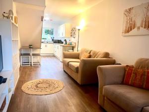 a living room with two couches and a kitchen at The Annexe, St Andrews house hotel, Two bedrooms Sleeps 4 in Preston