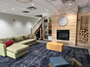 a living room with a couch and a fireplace at Comfort Inn & Suites Calhoun South in Calhoun