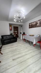 a living room with a black couch and a table at L'Alba in Magliano Alfieri