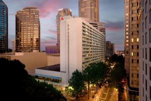 a tall white building in a city at night at Charlotte Marriott City Center in Charlotte