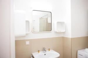 a bathroom with a sink and a mirror at Premium 80 m2 Rooftop Apartment - 5 min to Center in Vienna