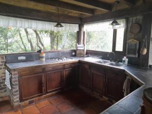 a kitchen with wooden cabinets and a sink at El Cobijo in Chocontá