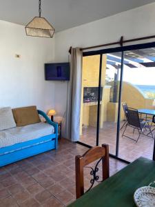 a living room with a couch and a table at Medanos del Portal in Piriápolis