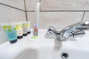 a bathroom sink with a toothbrush and toothpaste on it at Remarkable 1-Bed Studio in Birmingham in Birmingham