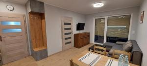 a living room with a couch and a table at Apartament Jantar in Jantar