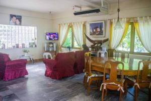 a living room with a table and a couch at Mangrove Inn 