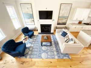 a living room with a couch and chairs and a fireplace at Magnolia Estate - 3 Separate Units, Courtyard in Savannah