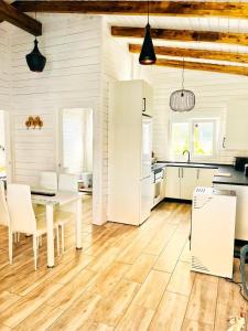 a kitchen with a white table and a white refrigerator at Eco alojamiento la Cartuja de Talamanca in Talamanca de Jarama