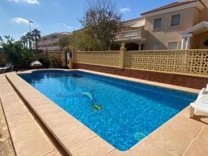 a swimming pool in front of a house at Navarro1 in Riumar