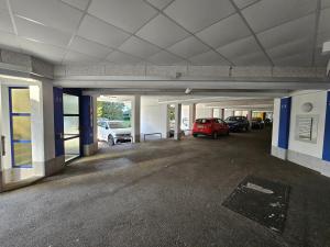 an empty parking garage with cars parked in it at Maxi's Home in Marchtrenk