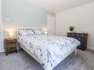 a bedroom with a bed and two night stands at 46 By The Creek in Faversham