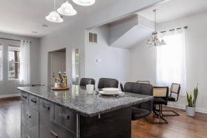 a kitchen with a large island with a counter top at Flexhome Logan Square Duplex 3BR Apt S2 - READ INFO in Chicago