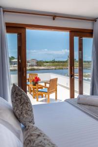 a bedroom with a bed and a table and chairs at Bahia Soul - Casa Cali - Barra Grande - Península de Maraú in Barra Grande