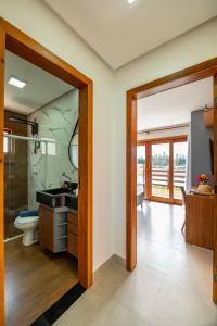 a bathroom with a sink and a toilet and a mirror at Bahia Soul - Casa Cali - Barra Grande - Península de Maraú in Barra Grande