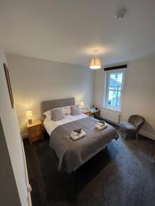 a bedroom with a bed with two towels on it at Dolly Waggon Guest House in Keswick