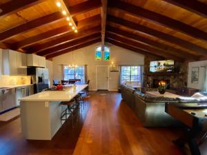 a large kitchen with wooden ceilings and wooden floors at Winter Getaway Spa Fire-table Close to slopes in Big Bear Lake