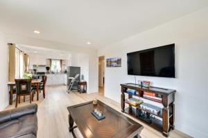 a living room with a couch and a flat screen tv at Sunny San Diego Vacation Rental with Private Yard! in San Diego