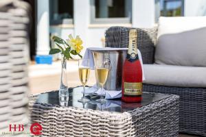 a bottle of champagne and two glasses on a table at Urban Hotel Santa Eulalia in Albufeira