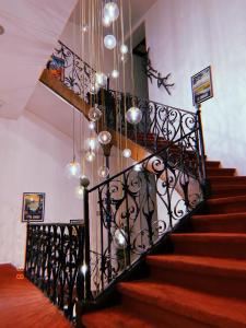 a staircase with a chandelier in a house at Hôtel De La Loge in Perpignan