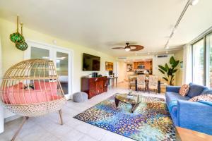 a living room with a blue couch and a bird cage at Island Oasis Near Kaanapali Beach and Black Rock in Lahaina