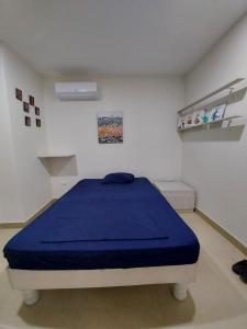 a bedroom with a blue bed in a room at Oasis Suite Salinas in Salinas