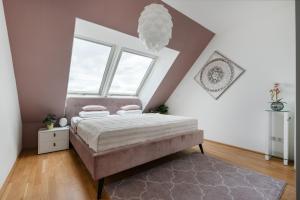 a bedroom with a bed and a large window at Luxurious living with beautiful terrace in Vienna