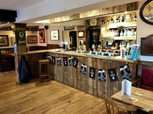 a bar in a restaurant with a wooden wall at The Windsor Trooper in Windsor