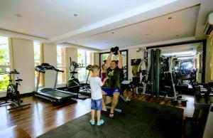 a man and a young boy in a gym at Beautiful 1 BHK With Pool Wi-Fi Cooking Gas Gym Caretakers in Old Goa